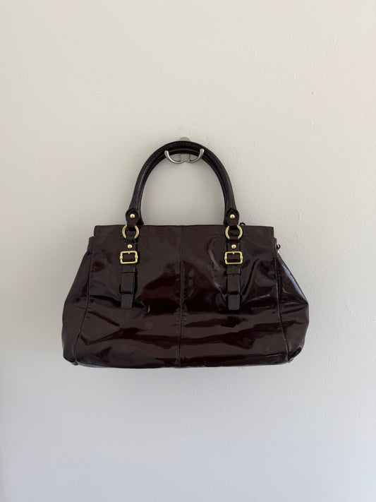 deep plum with gold hardware on a white background