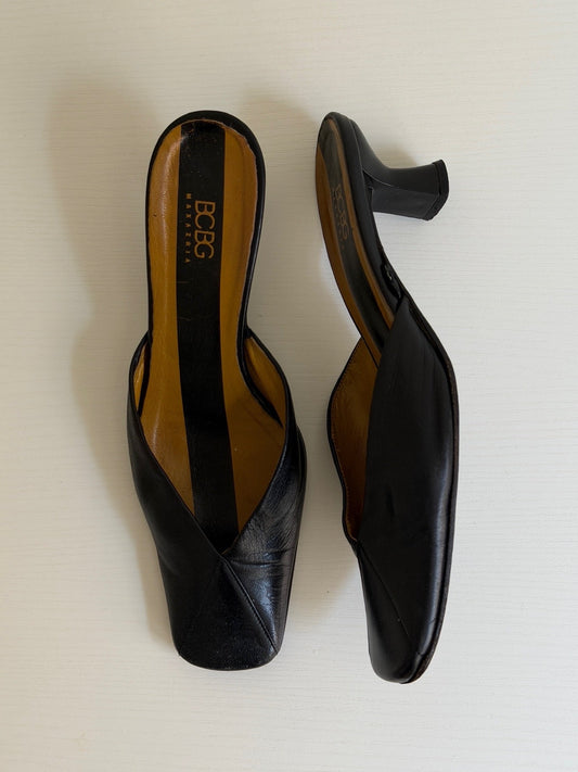 Pair of black high-heeled shoes on a white background