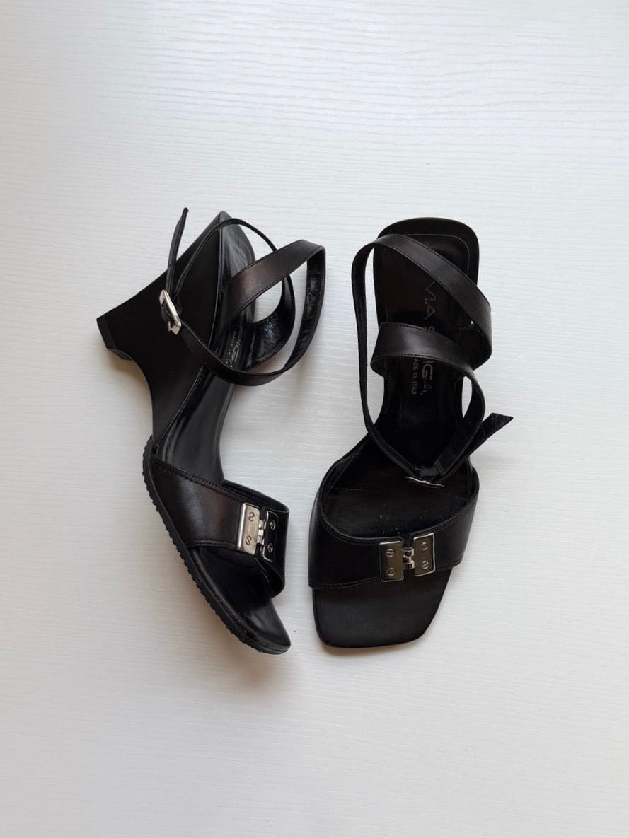 Pair of black high-heeled sandals on a white background