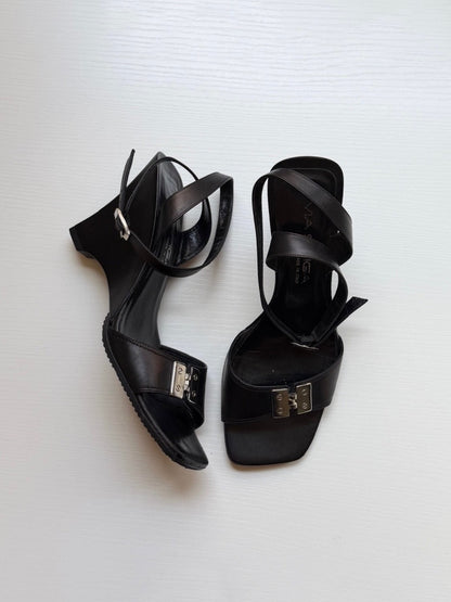 Pair of black high-heeled sandals on a white background