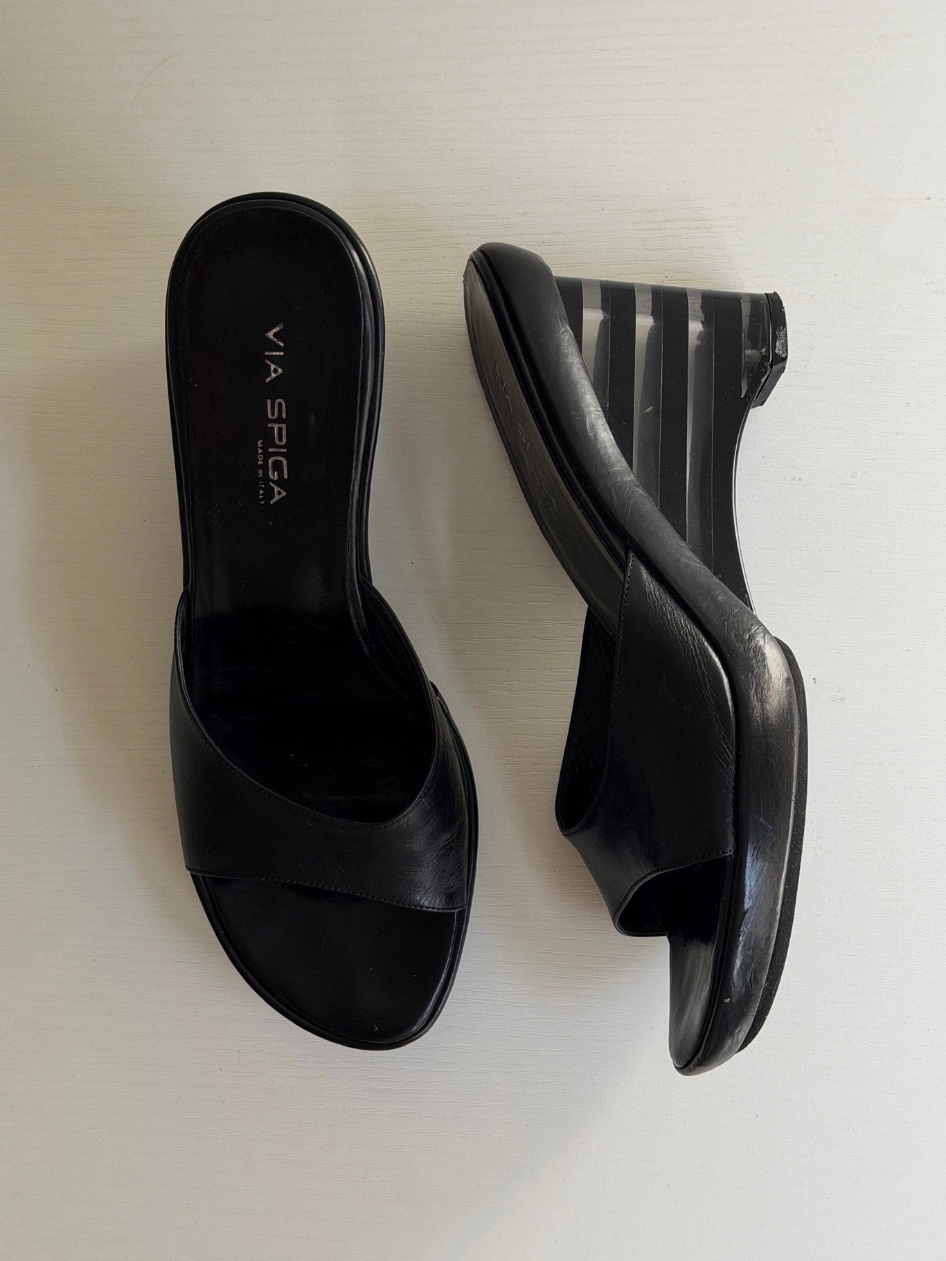 Pair of black open-toe high-heeled shoes on a white background