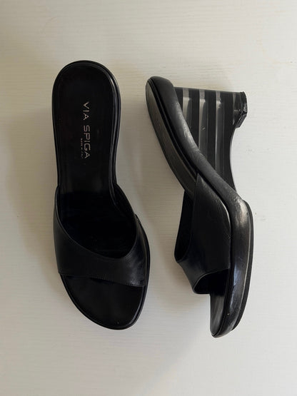 Pair of black open-toe high-heeled shoes on a white background