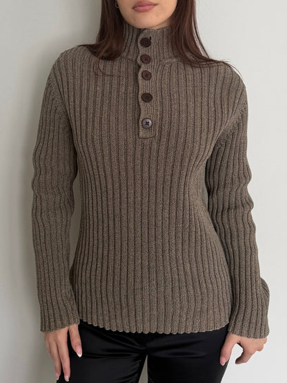 Brown ribbed sweater with button details worn by a person against a plain background
