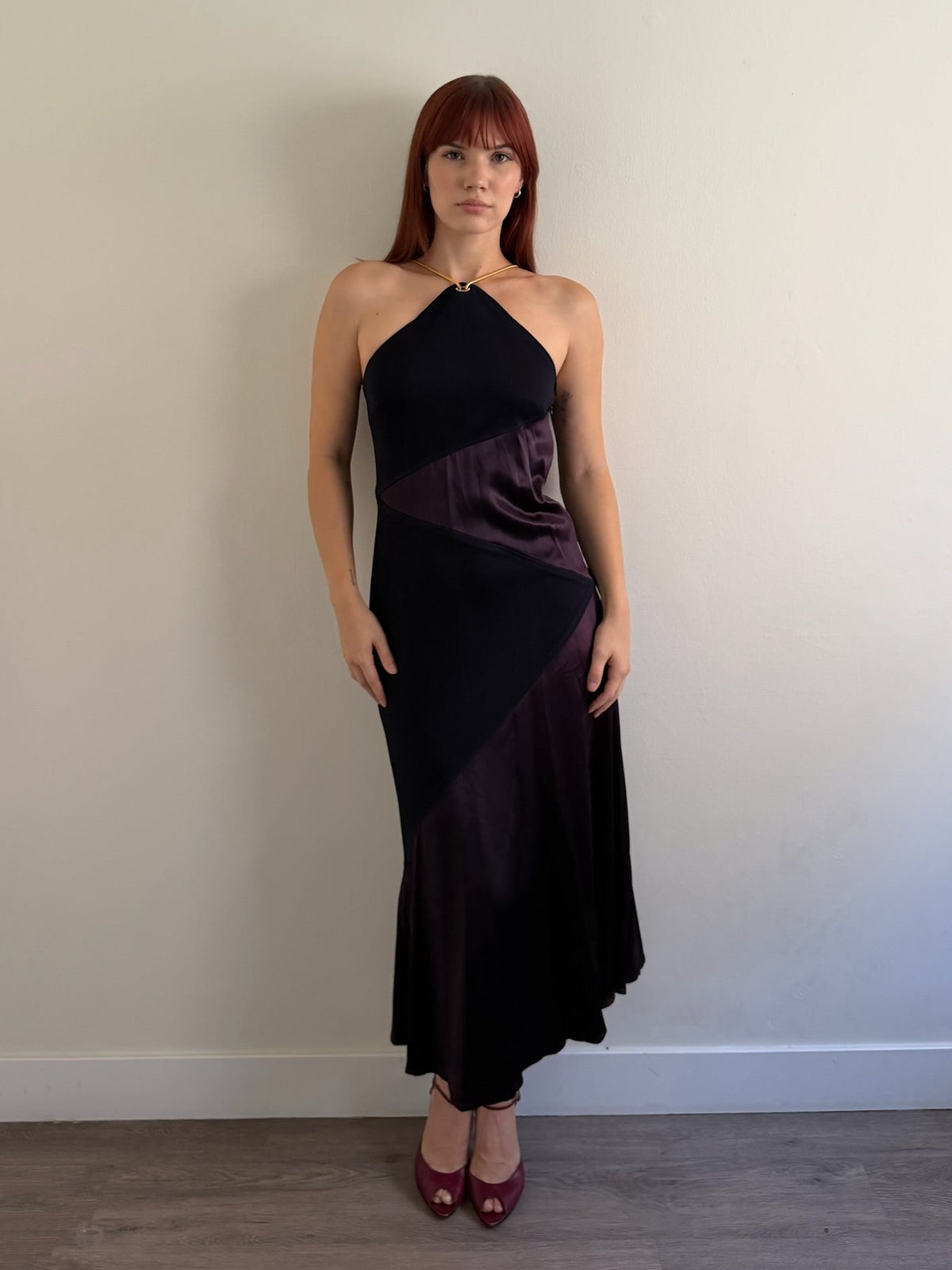 front of halter neck dress with red shoes infant of white wall
