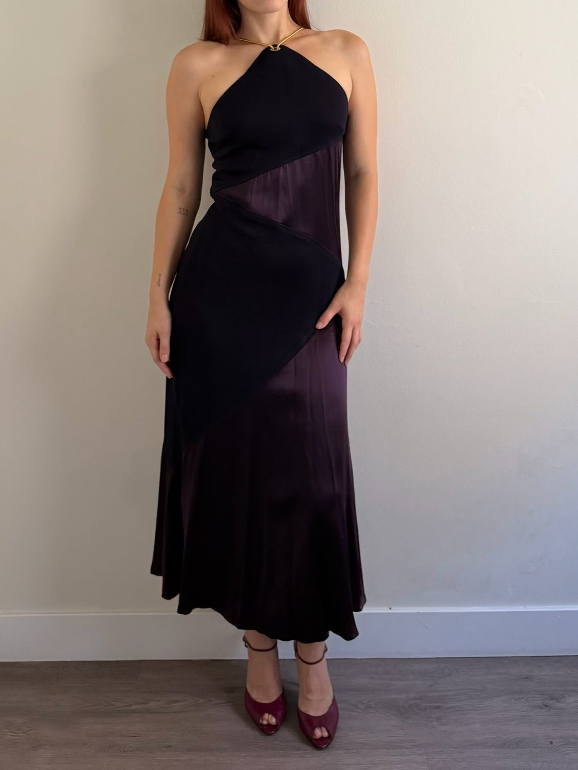 front of halter neck dress with red shoes infant of white wall