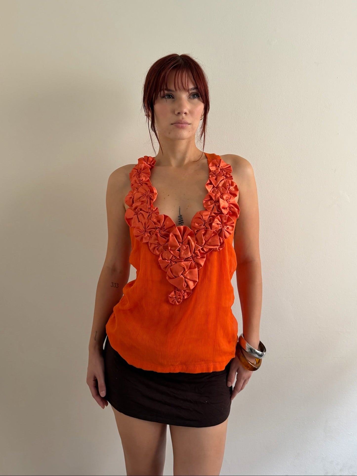 orange top and brown skirt
