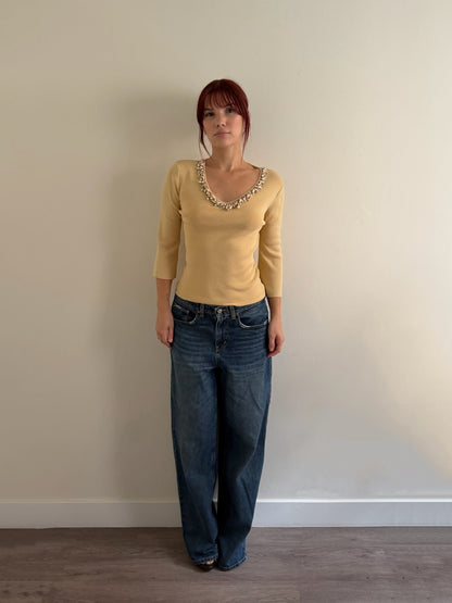 cream top with denim infant of white wall