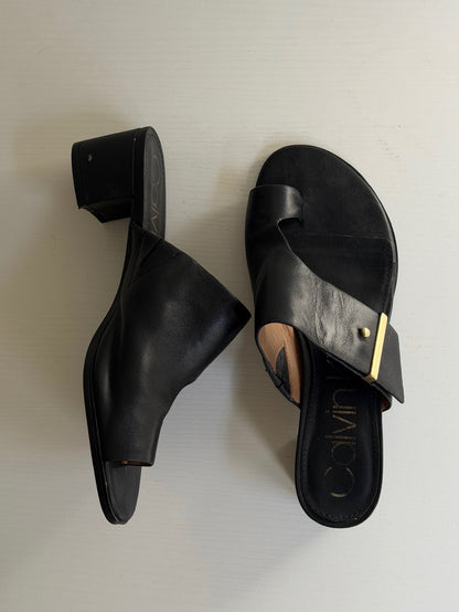 Pair of black sandals on a light gray background