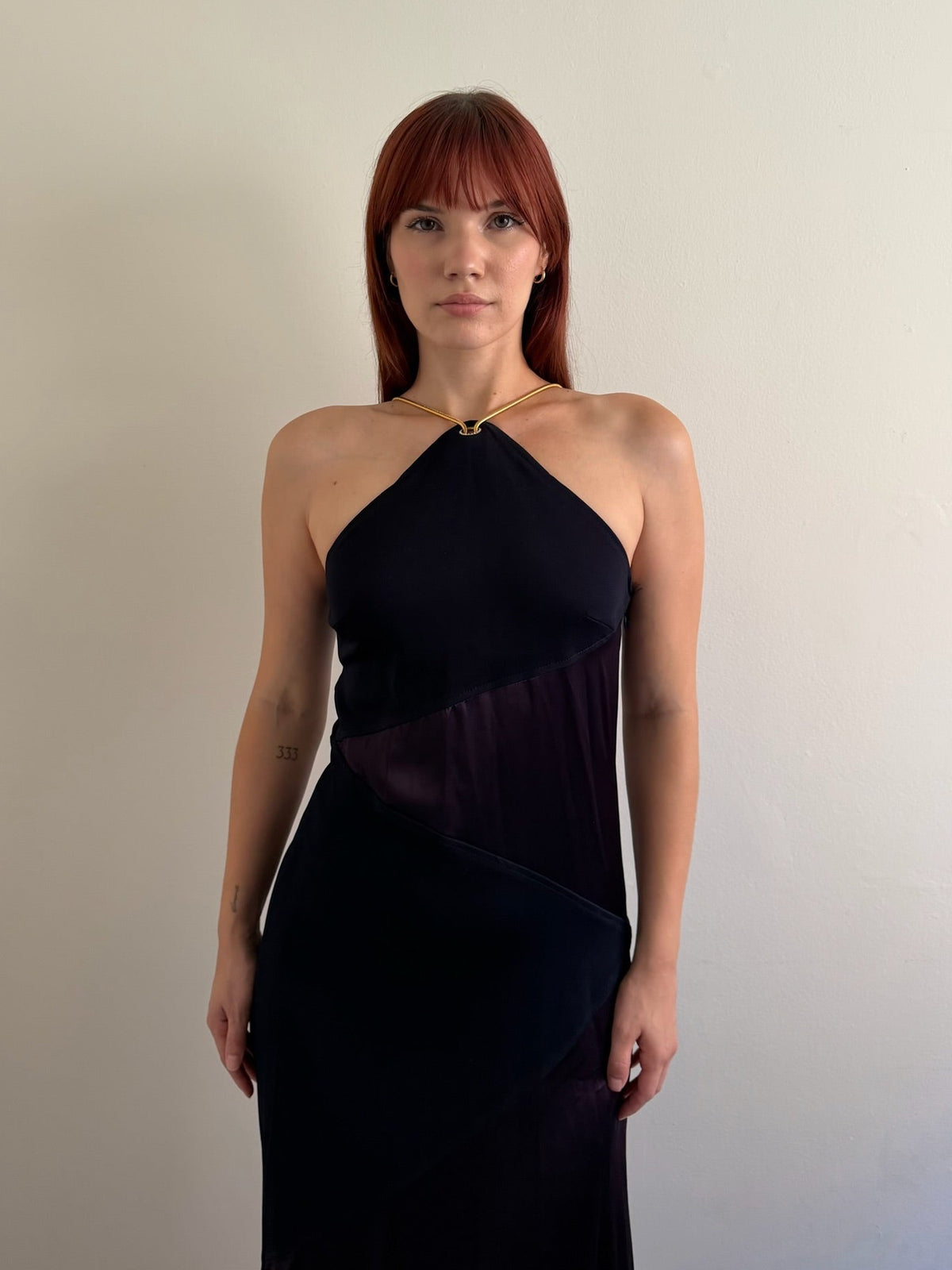 front of halter neck dress with red shoes infant of white wall