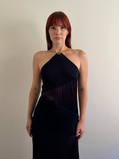 front of halter neck dress with red shoes infant of white wall