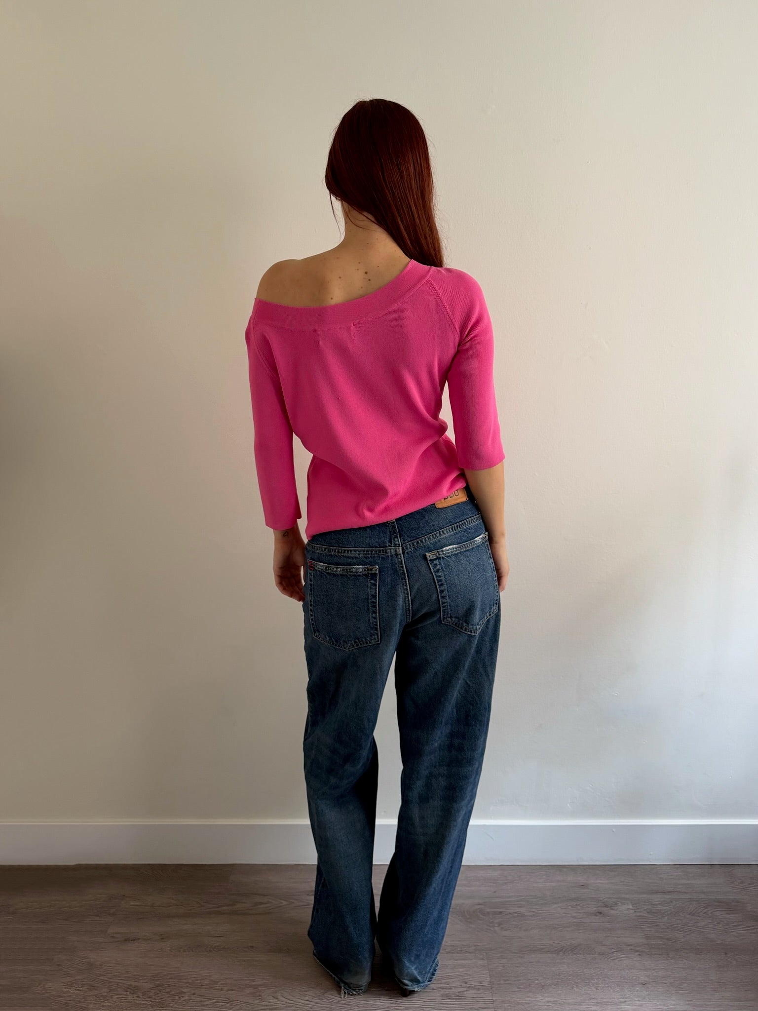 back of pink top and denim jeans outfit