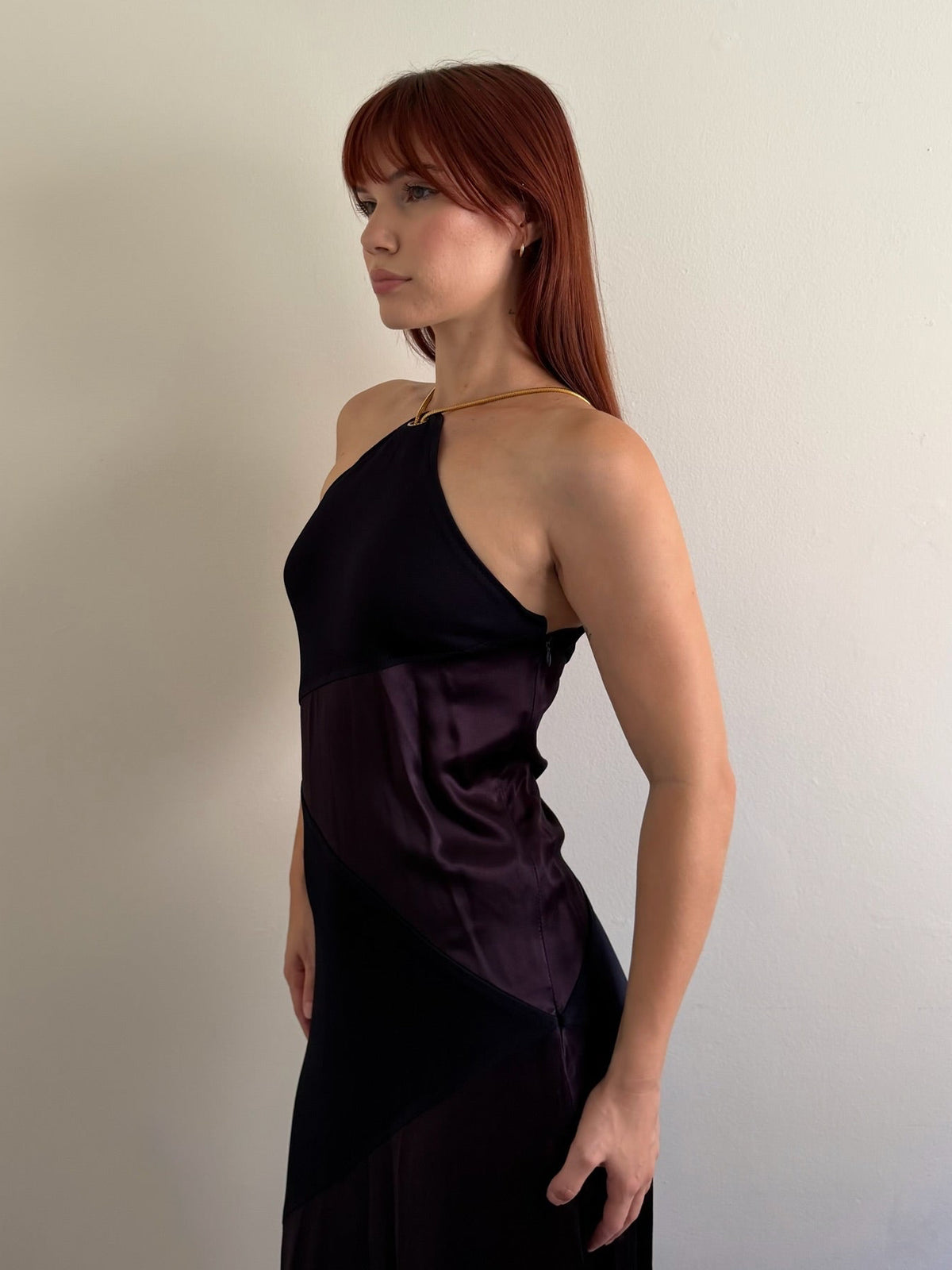 front side of halter neck dress with red shoes infant of white wall