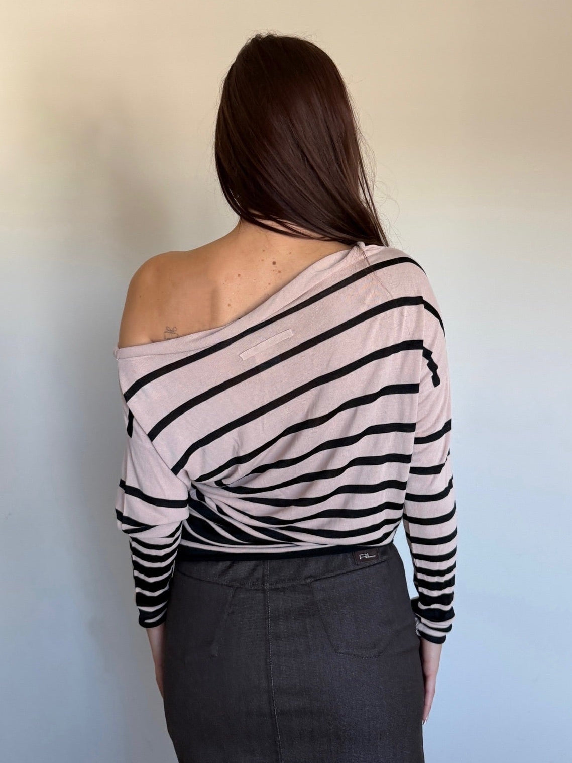 back of a cream and black longsleeve that is off the shoulder