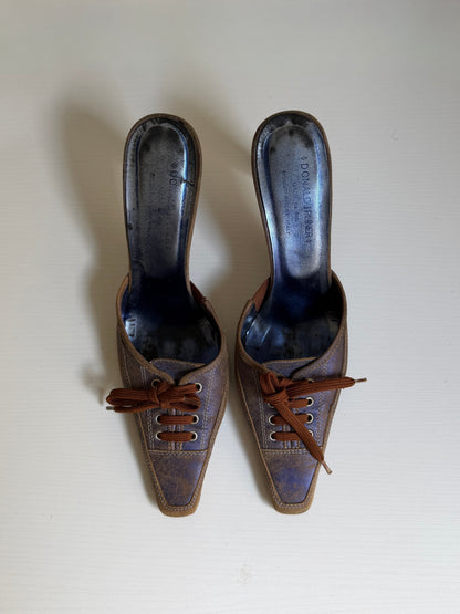 Pair of brown leather shoes with laces on a white background