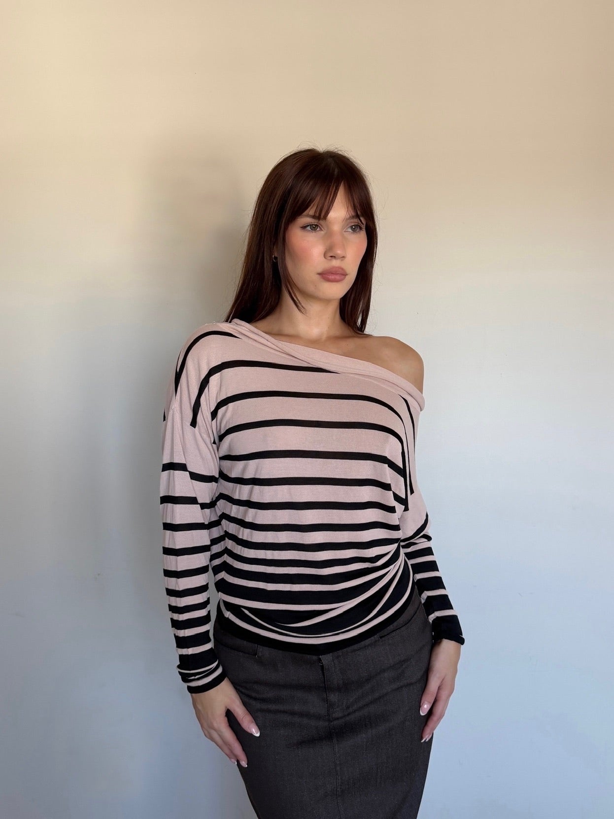 cream and black longsleeve that is off the shoulder