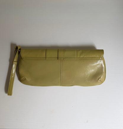 Green clutch bag on a white surface