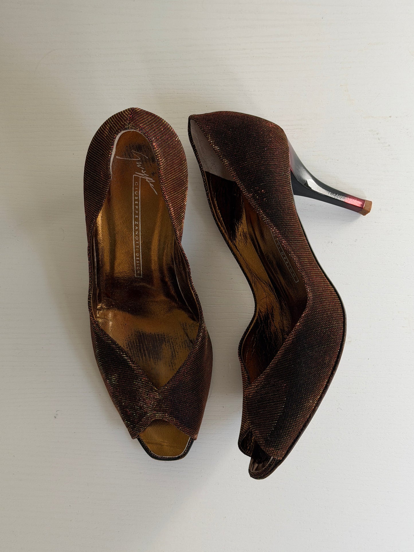 Pair of brown high-heeled shoes on a white background
