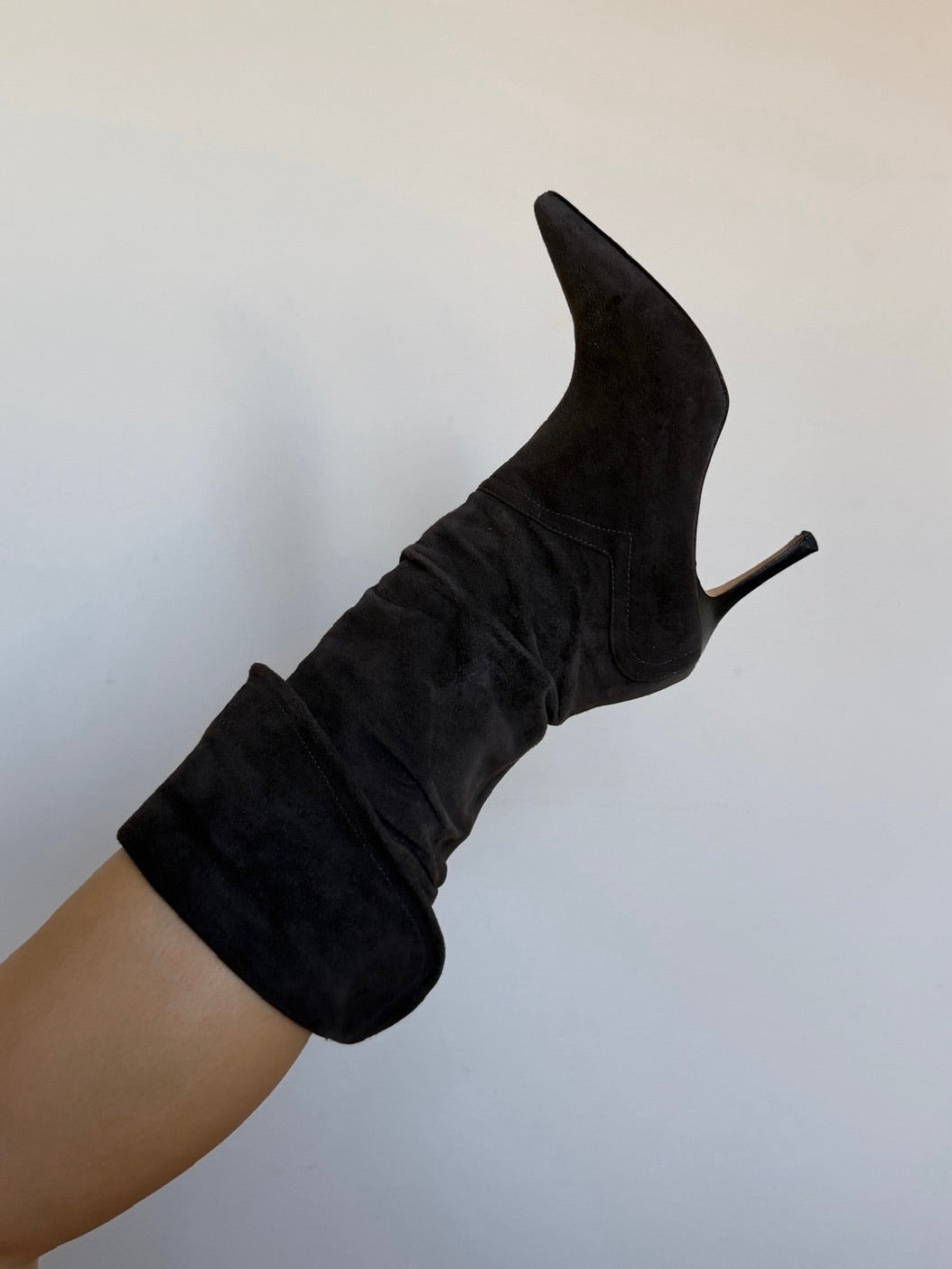 Black sock boot on a mannequin leg against a plain background