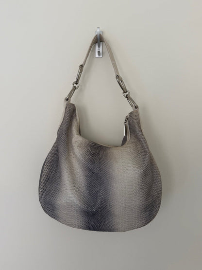 Gray textured handbag hanging on a white wall