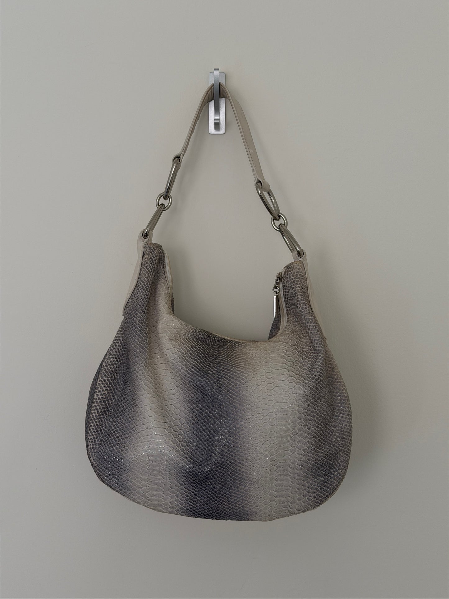 Gray handbag with chain handle on a light gray background
