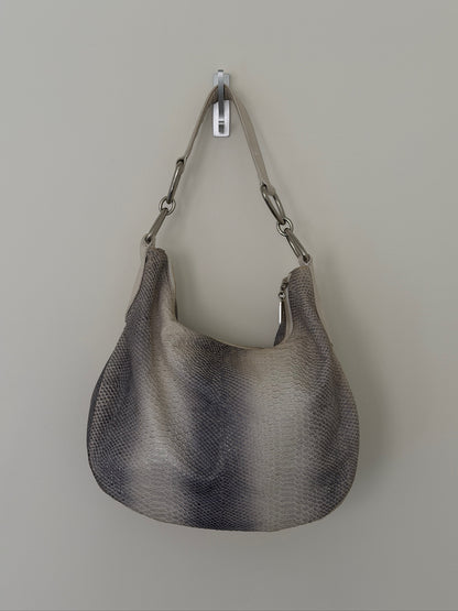 Gray handbag with chain handle on a light gray background