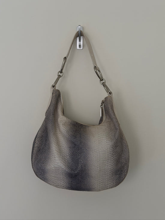Gray handbag with chain handle on a light gray background
