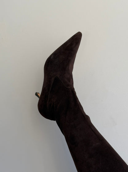 Dark brown knee-high boot on a light gray background