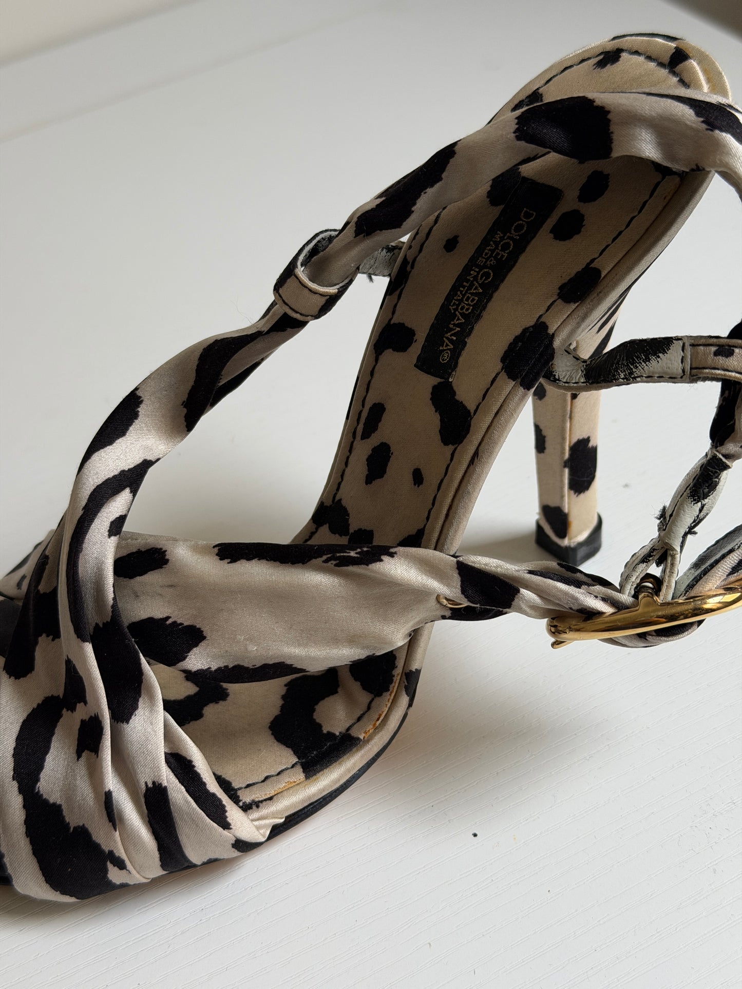Leopard print sandal with a visible brand name on a white background