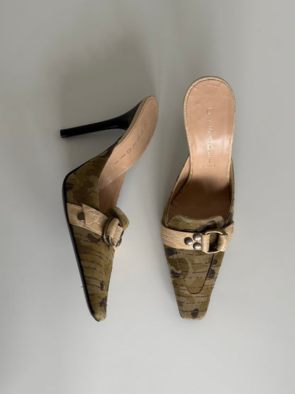 Pair of cork sandals with a buckle on a light gray background