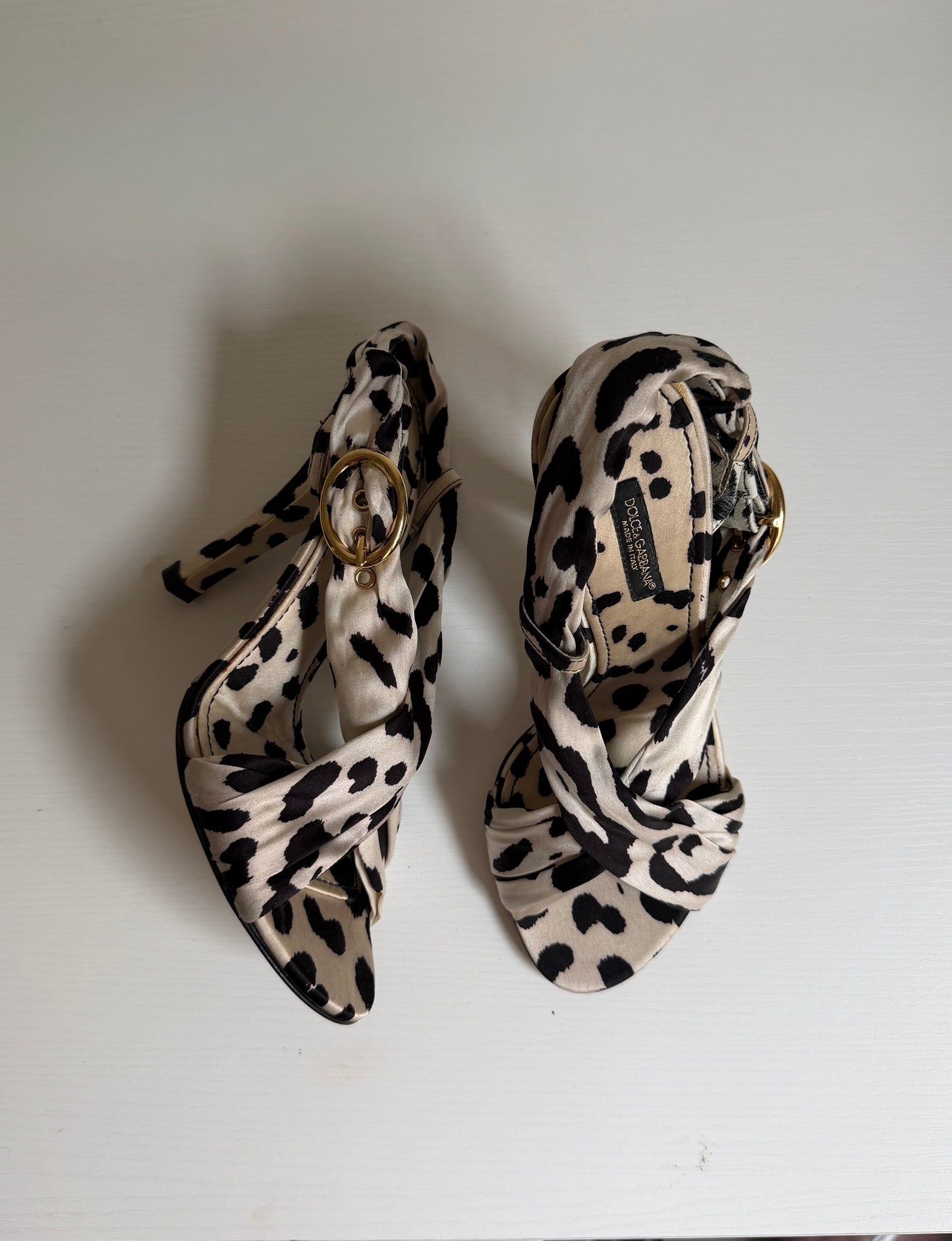 Pair of leopard print high heels on a white surface