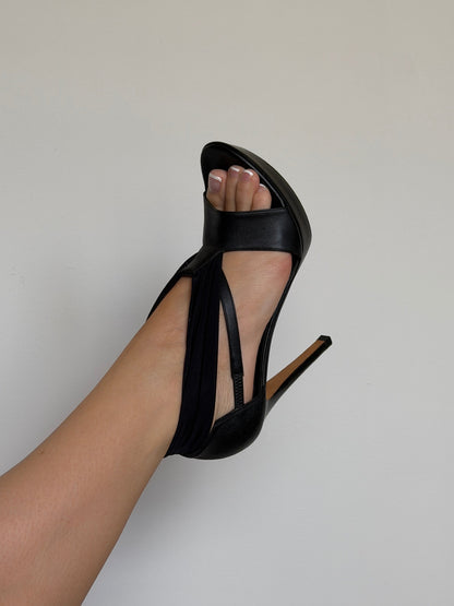 Black high-heeled sandal on a neutral background