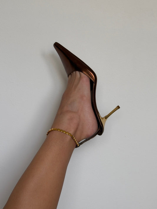 Brown high-heeled shoe on a white background