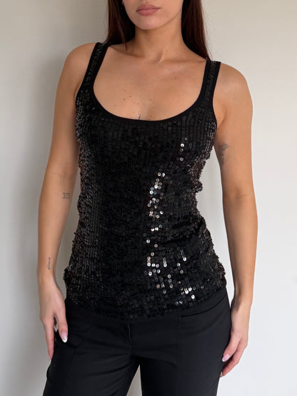 Black sequin tank top worn by a person against a neutral background