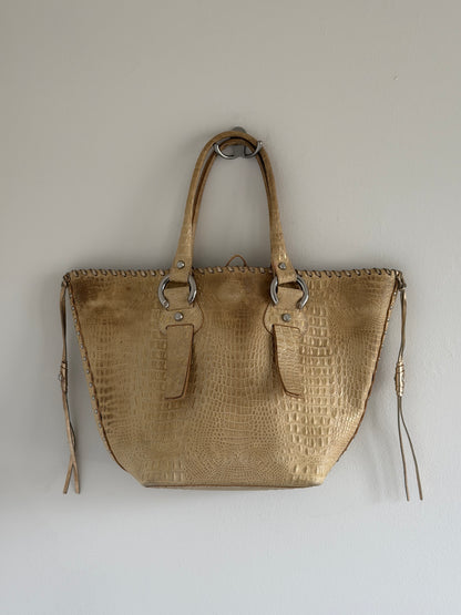 Beige textured handbag on a light gray background