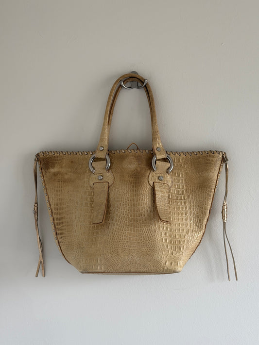 Beige textured handbag on a light gray background