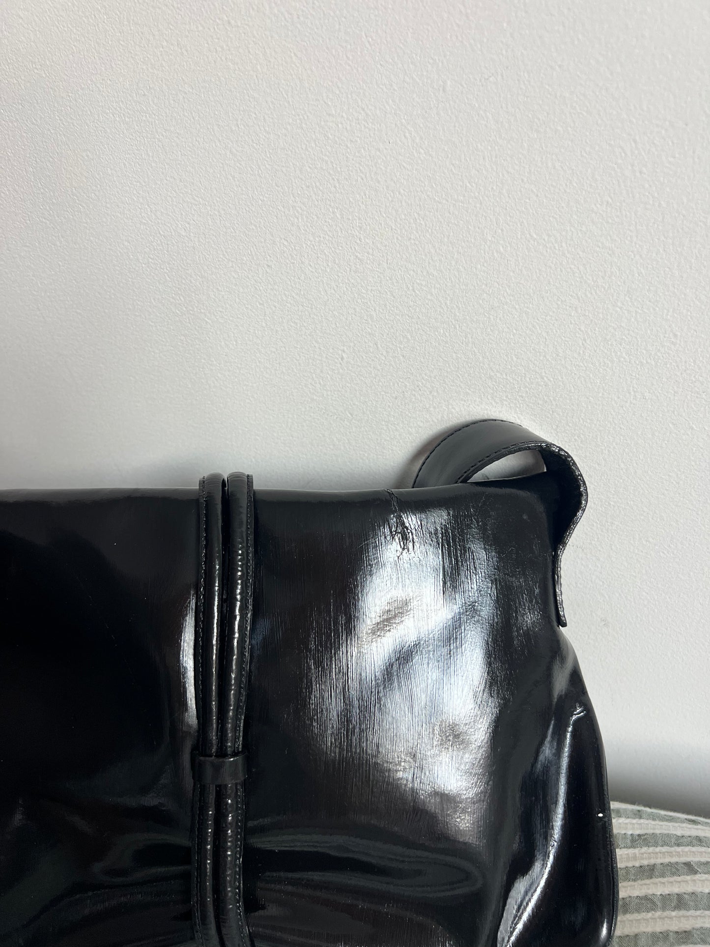 Black shiny shoes on a light gray background