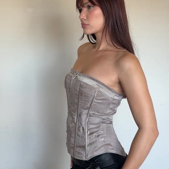 video of a women wearing a metallic corset top with black pants