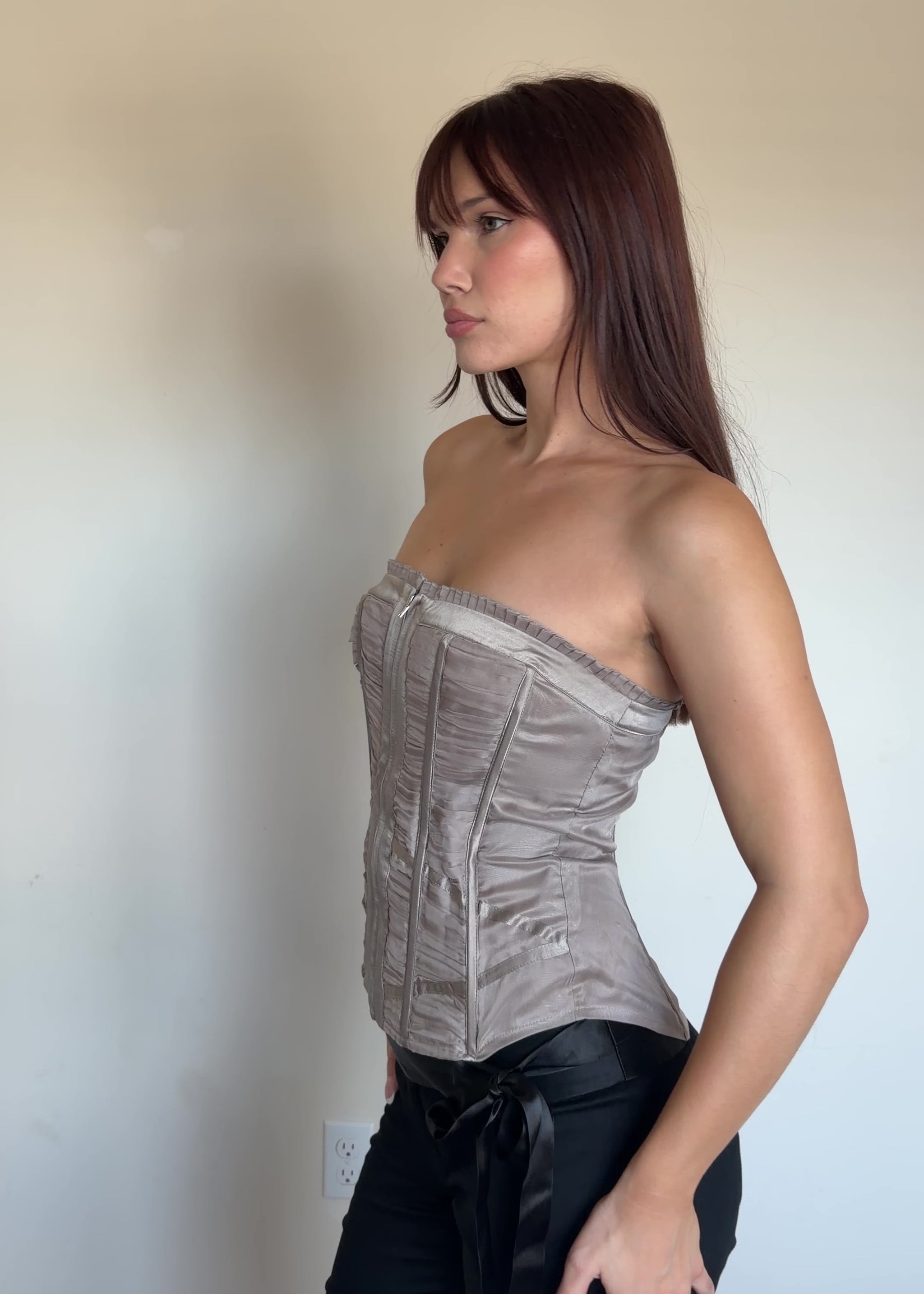 video of a women wearing a metallic corset top with black pants