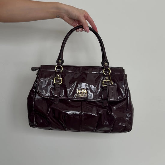 video of deep plum coach handbag