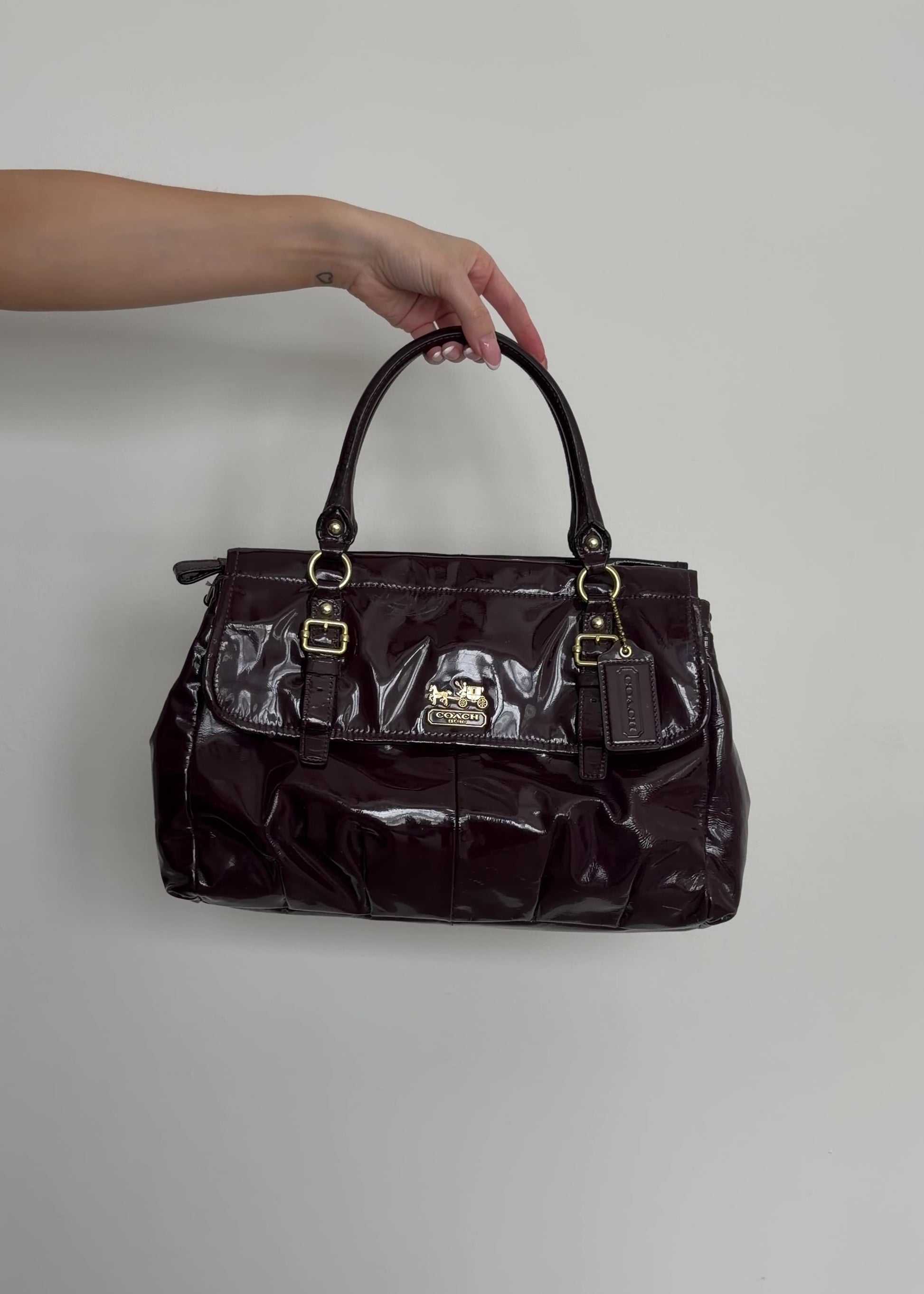 video of deep plum coach handbag