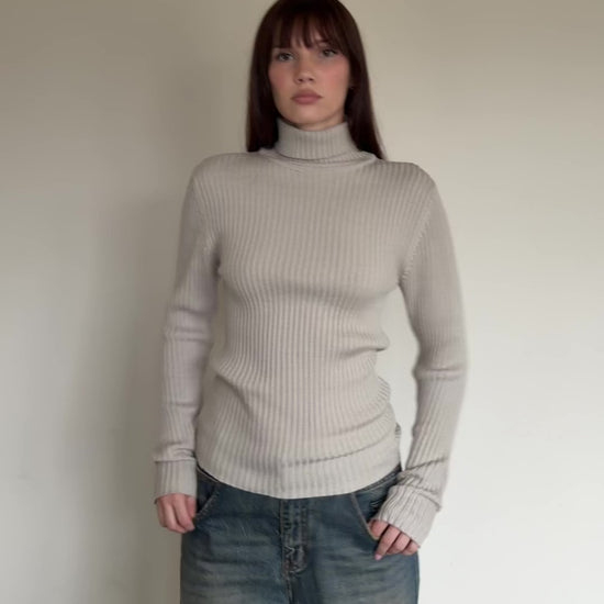 womem wearing beige turtleneck sweater