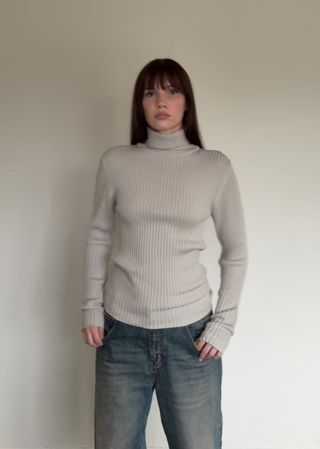 womem wearing beige turtleneck sweater