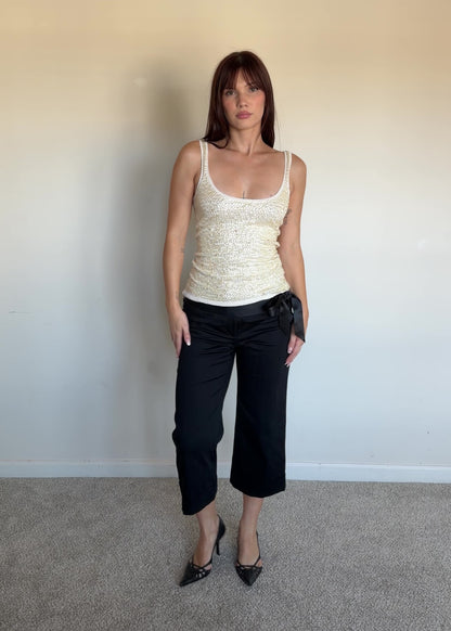 video of a cream sequin top with black capris 