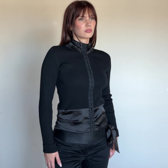 women wearing a black turtleneck with satin detail