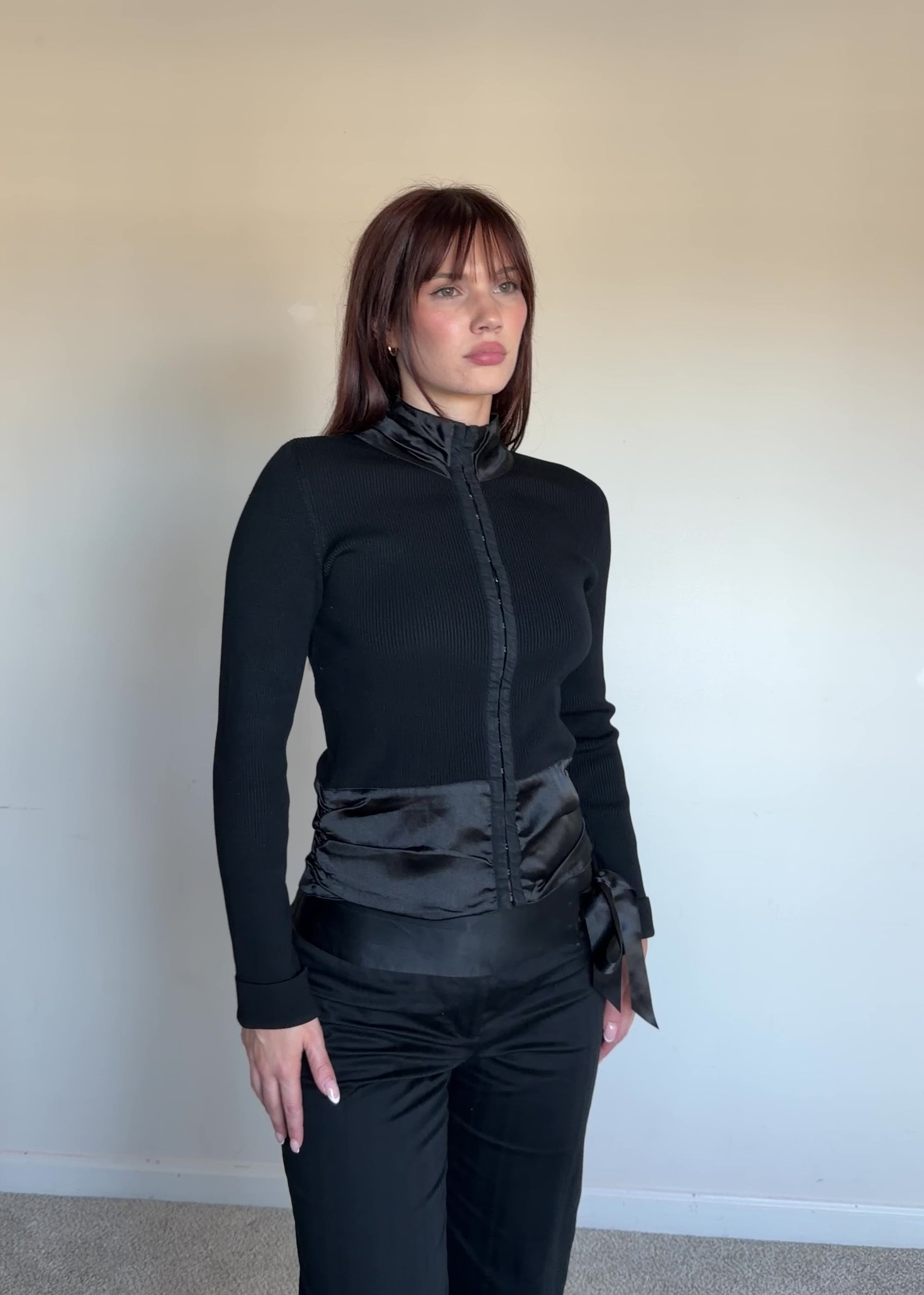 women wearing a black turtleneck with satin detail