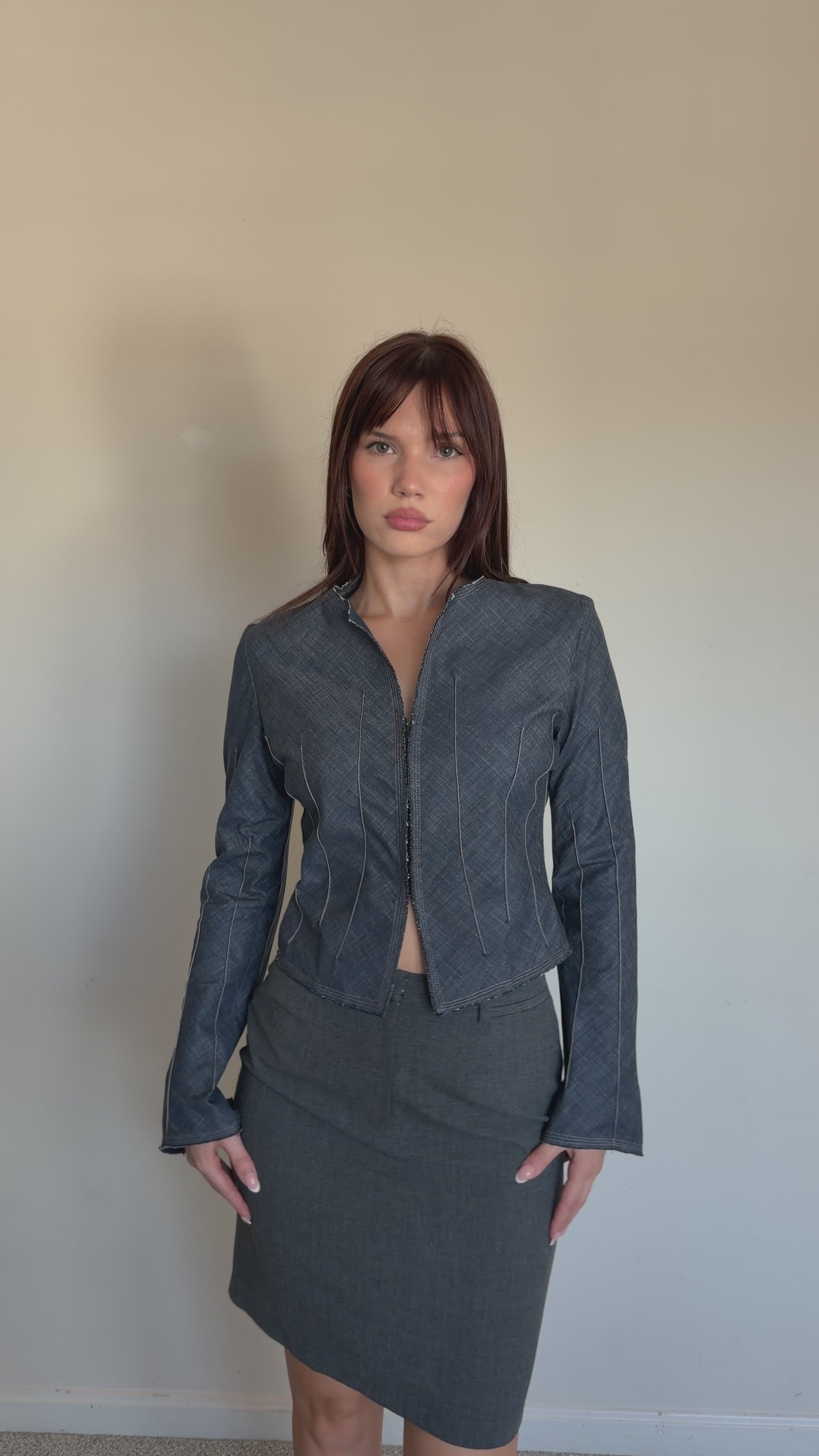 video of cropped denim jacket with grey pencil skirt 